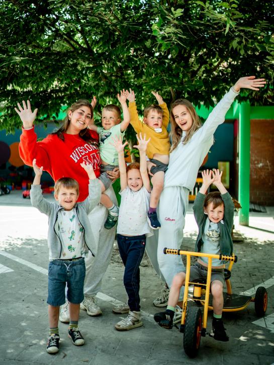 Illustratieve foto van animators die samen met kinderen poseren.